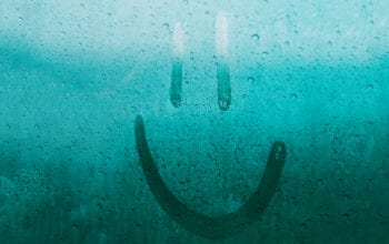 Smiley face finger drawn on a wet window | Dockside Cannabis